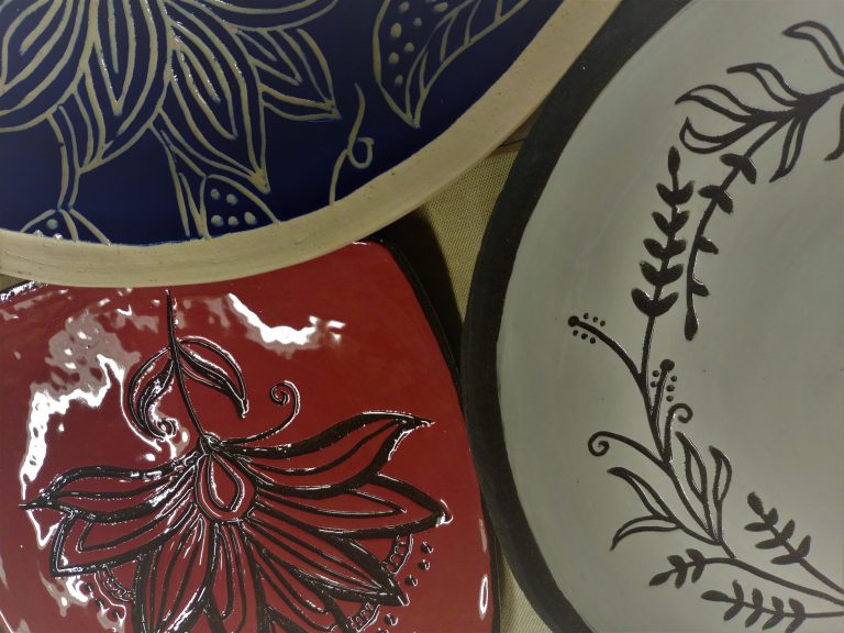 Ceramic plates, slip-carved, transparent glaze